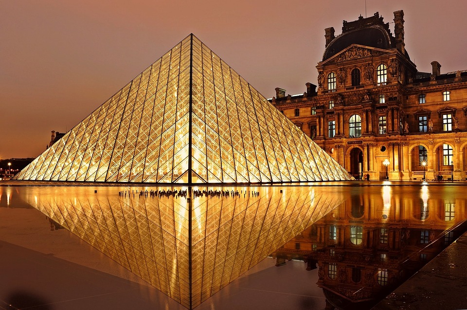 Louvre Museum glass and metal pyramid lit up at night